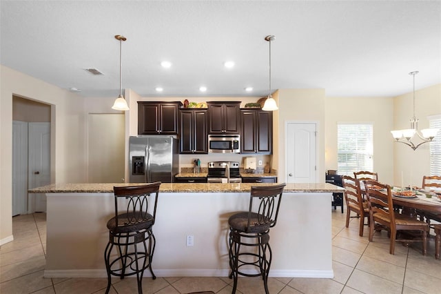 1286 Tallow Rd, Apopka, FL 32703 - kitchen with stainless steel appliances, a kitchen breakfast bar, dark brown cabinets, a large island with sink, and recessed lighting