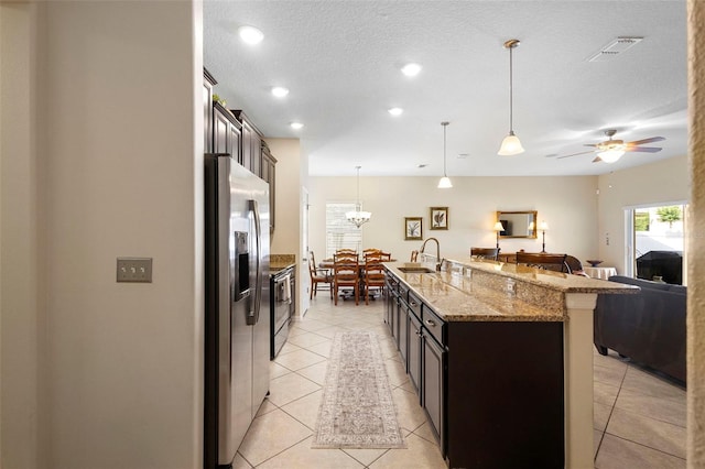 1286 Tallow Rd, Apopka, FL 32703 - kitchen with appliances with stainless steel finishes, a sink, open floor plan, a kitchen bar, and light stone countertops