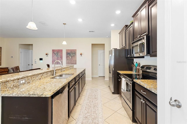 1286 Tallow Rd, Apopka, FL 32703 - kitchen with stainless steel appliances, a sink, an island with sink, dark brown cabinetry, and pendant lighting