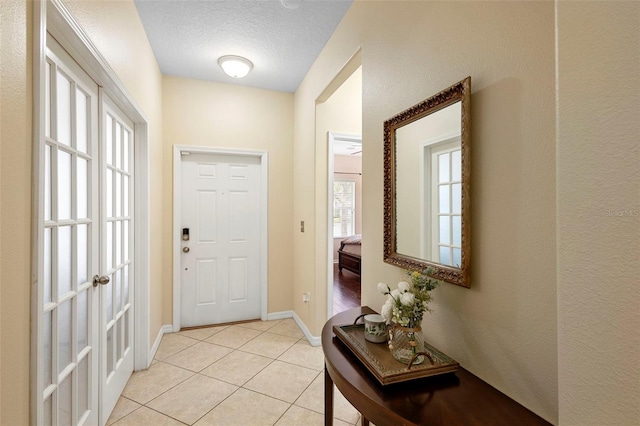 1286 Tallow Rd, Apopka, FL 32703 - doorway to outside with light tile patterned floors, a textured ceiling, and baseboards