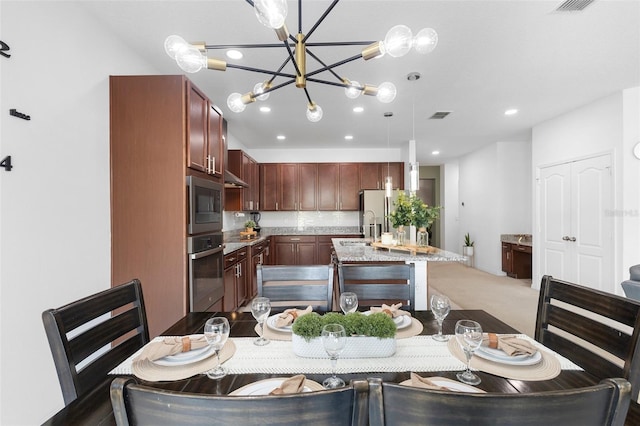 dining area featuring a chandelier and recessed lighting