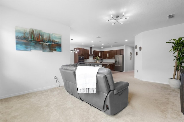 living area featuring light colored carpet, baseboards, recessed lighting, and a chandelier