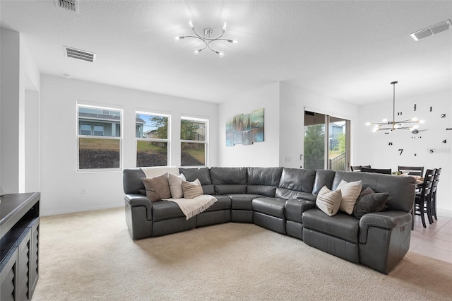 living area with a chandelier, light carpet, and baseboards