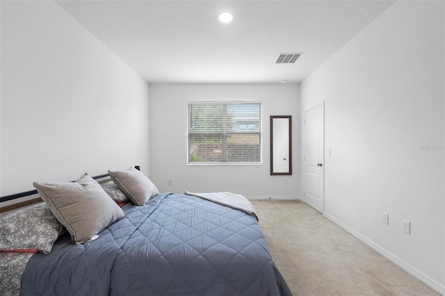 bedroom with light colored carpet, baseboards, and recessed lighting