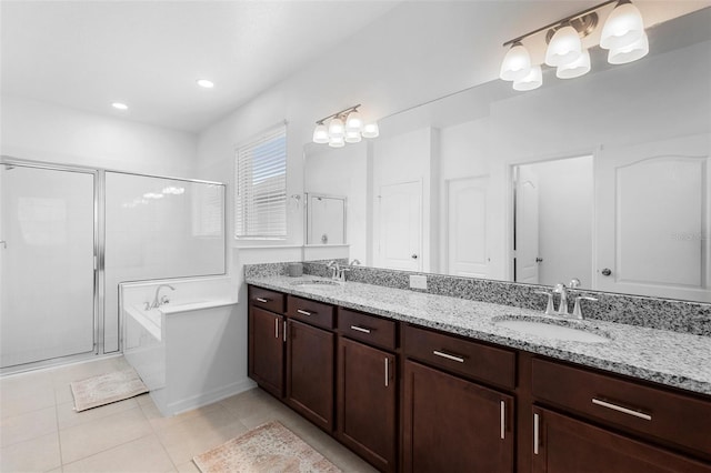 bathroom featuring a shower stall, tile patterned floors, double vanity, a garden tub, and recessed lighting