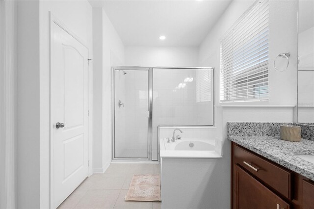 full bath featuring a shower stall, vanity, tile patterned floors, and a bath