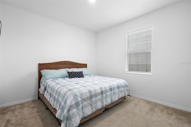 bedroom featuring carpet and baseboards