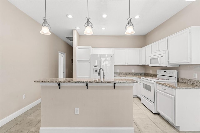 kitchen featuring white appliances, an island with sink, white cabinets, light tile patterned flooring, and recessed lighting