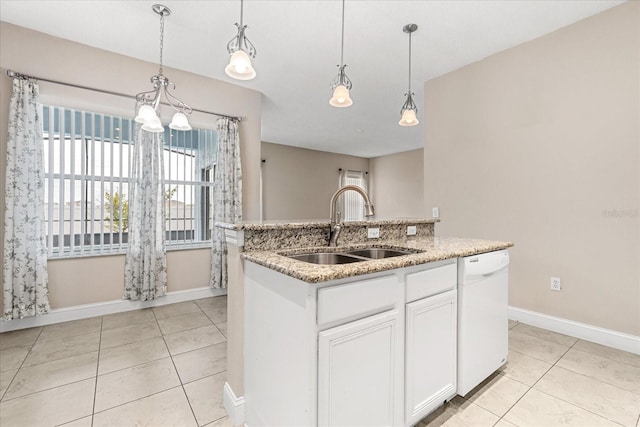 kitchen with white dishwasher, a sink, baseboards, and decorative light fixtures