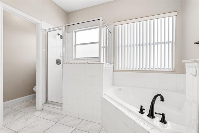 bathroom with a shower stall, a garden tub, and toilet
