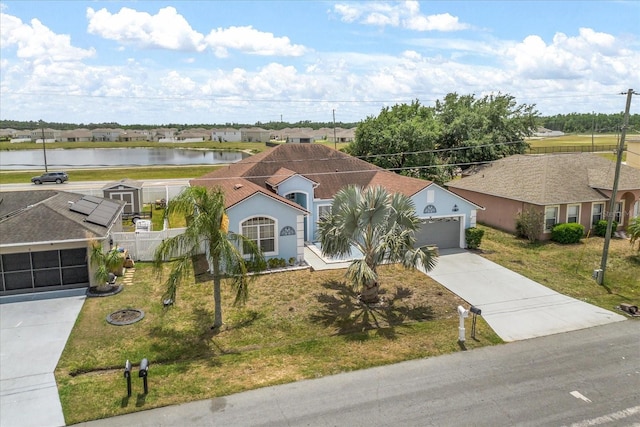 view of front of home with concrete driveway and a water view