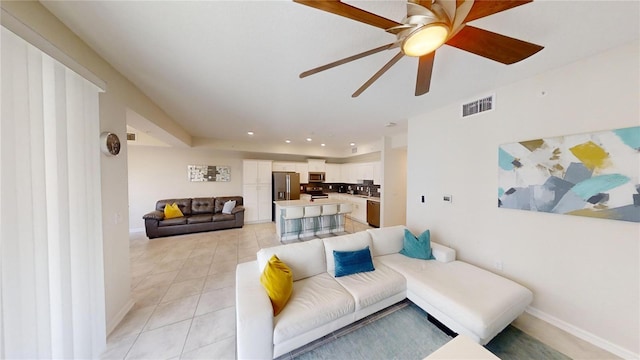 3150 Paradox Cir Unit 102, Kissimmee, FL 34746 - living room featuring a ceiling fan, light tile patterned floors, baseboards, and recessed lighting