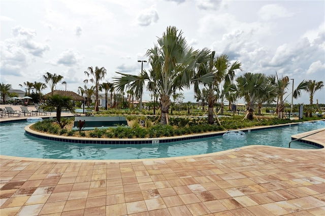 3150 Paradox Cir Unit 102, Kissimmee, FL 34746 - community pool with a patio area