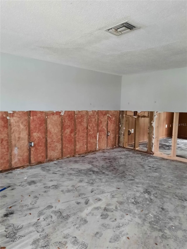 7240 Donna Dr, New Port Richey, FL 34652 - unfurnished room featuring unfinished concrete floors and a textured ceiling