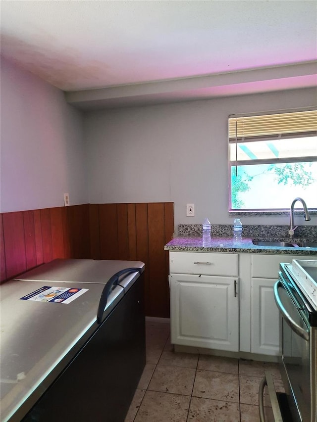 7240 Donna Dr, New Port Richey, FL 34652 - kitchen with range with electric cooktop, white cabinets, a sink, and light tile patterned flooring