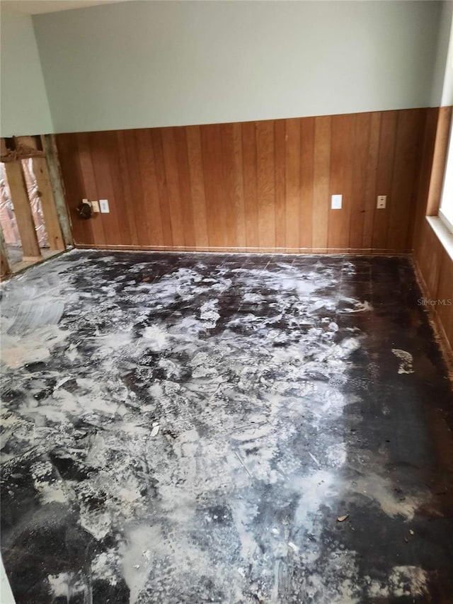7240 Donna Dr, New Port Richey, FL 34652 - unfurnished room featuring wooden walls and concrete floors