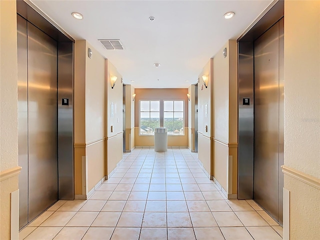 8101 Resort Village Dr, Orlando, FL 32821 - hall featuring elevator and light tile patterned floors
