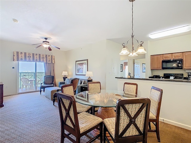 8101 Resort Village Dr, Orlando, FL 32821 - dining space featuring baseboards, a chandelier, a ceiling fan, and light colored carpet