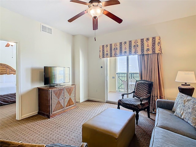 8101 Resort Village Dr, Orlando, FL 32821 - carpeted living room with ceiling fan and baseboards