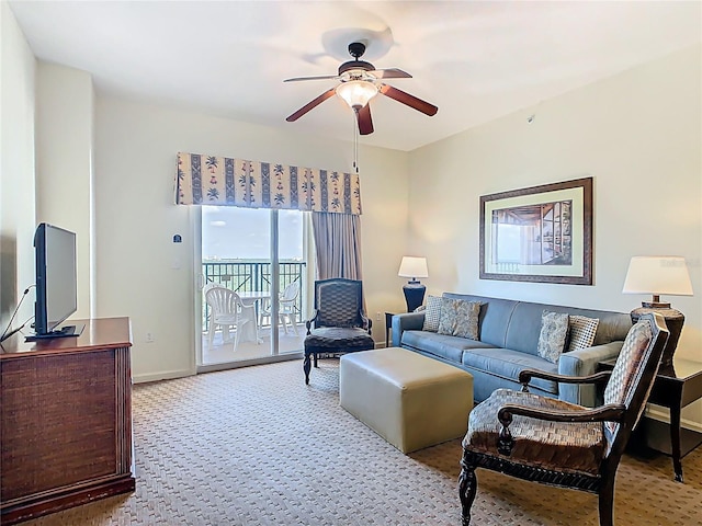 8101 Resort Village Dr, Orlando, FL 32821 - living area with a ceiling fan, carpet flooring, and baseboards
