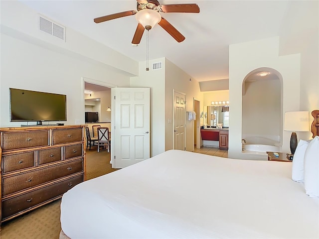 8101 Resort Village Dr, Orlando, FL 32821 - bedroom featuring ensuite bath, arched walkways, light carpet, and a ceiling fan