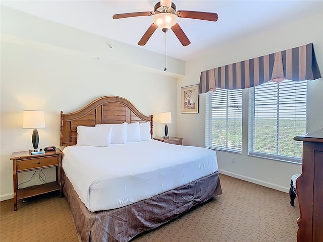 8101 Resort Village Dr, Orlando, FL 32821 - bedroom featuring light carpet, baseboards, and a ceiling fan