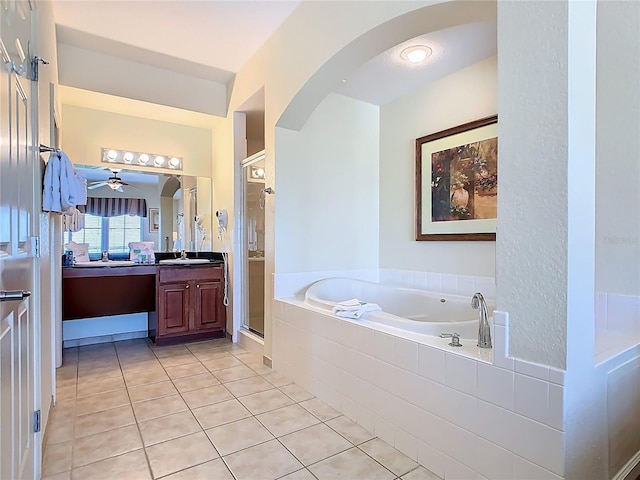8101 Resort Village Dr, Orlando, FL 32821 - full bathroom featuring tile patterned flooring, a stall shower, a garden tub, vanity, and a ceiling fan