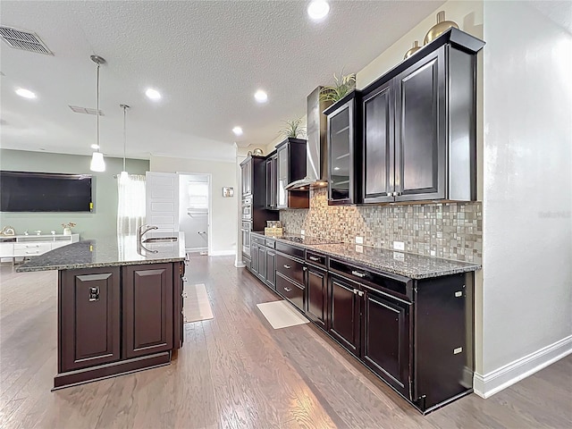 473 Oviedo Blvd, Oviedo, FL 32765 - kitchen with wall chimney exhaust hood, wood finished floors, stone counters, a textured ceiling, and recessed lighting