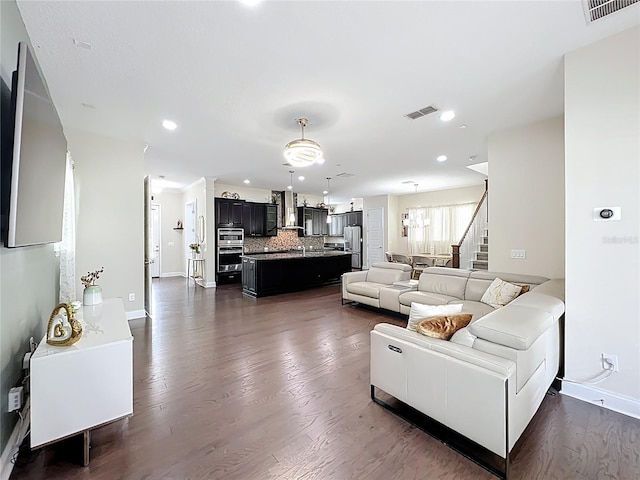 473 Oviedo Blvd, Oviedo, FL 32765 - living area with stairs, baseboards, dark wood-type flooring, and recessed lighting