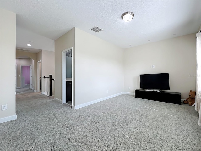 473 Oviedo Blvd, Oviedo, FL 32765 - unfurnished living room featuring carpet, baseboards, arched walkways, and a textured ceiling
