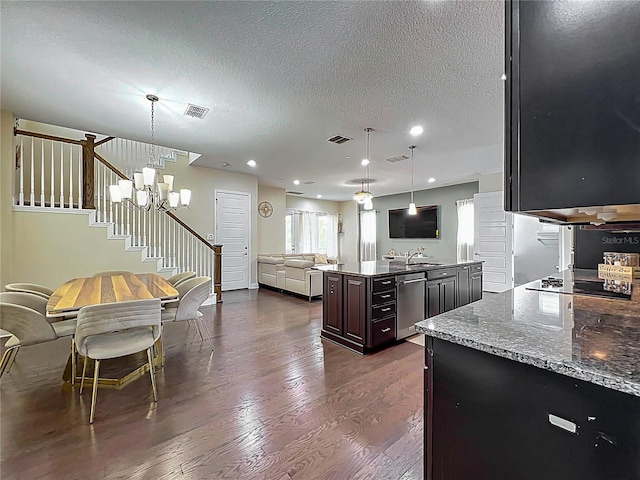473 Oviedo Blvd, Oviedo, FL 32765 - kitchen featuring dishwasher, black electric stovetop, open floor plan, dark wood finished floors, and a center island with sink