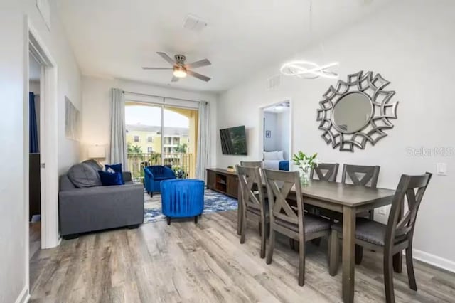 dining room with wood finished floors and ceiling fan