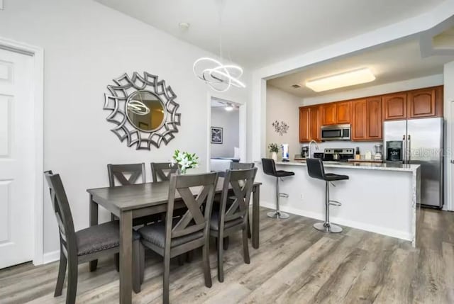 dining space with light wood-type flooring