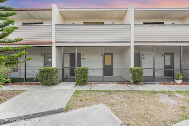 3164 Finsterwald Dr Unit 3164, Titusville, FL 32780 - back of property at dusk featuring a balcony