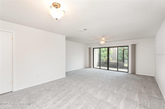 3164 Finsterwald Dr Unit 3164, Titusville, FL 32780 - empty room featuring ceiling fan, light carpet, a textured ceiling, and baseboards