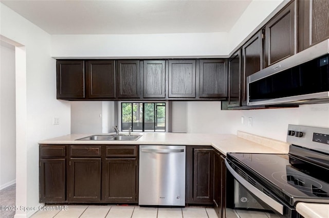 3164 Finsterwald Dr Unit 3164, Titusville, FL 32780 - kitchen featuring stainless steel appliances, a sink, dark brown cabinetry, light countertops, and light tile patterned floors