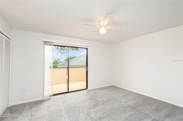 3164 Finsterwald Dr Unit 3164, Titusville, FL 32780 - unfurnished bedroom featuring access to exterior, carpet floors, baseboards, a textured ceiling, and ceiling fan