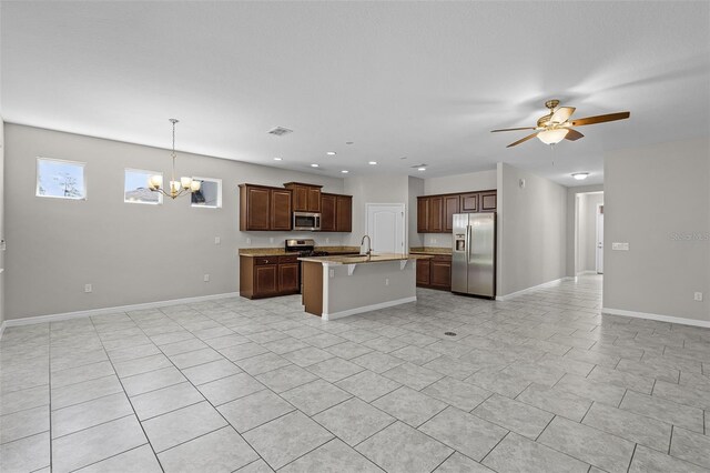 kitchen featuring stainless steel appliances, open floor plan, a chandelier, a sink, and recessed lighting