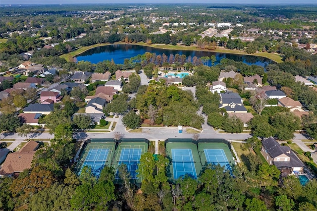 aerial view of property and surrounding area with a large body of water and nearby suburban area