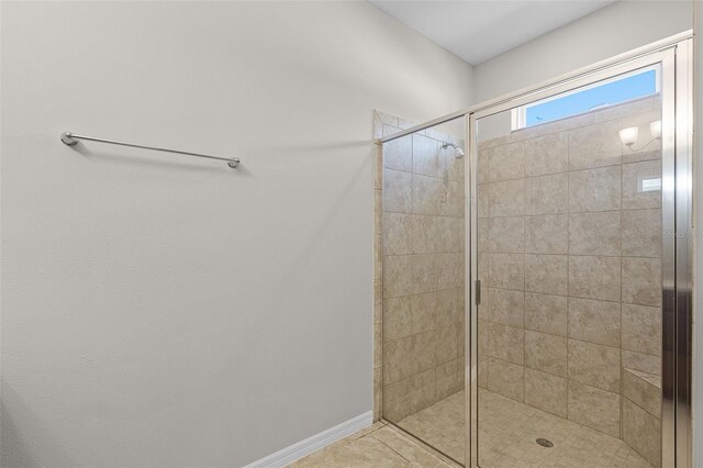 full bath featuring a shower stall and tile patterned floors