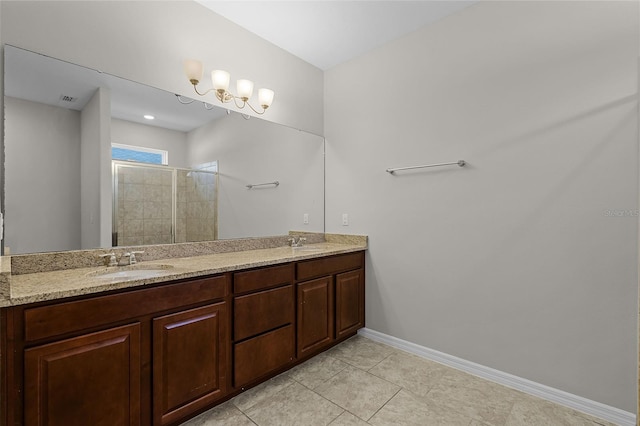 bathroom featuring a shower stall, baseboards, double vanity, and tile patterned floors