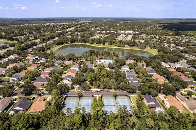 aerial view of property and surrounding area with a large body of water and nearby suburban area