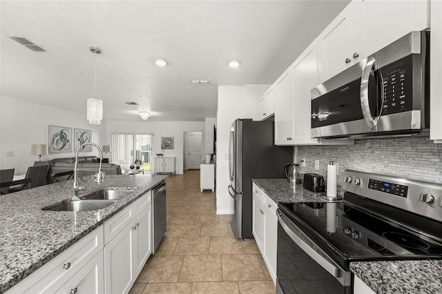 16162 Arbor Crest Aly, Winter Garden, FL 34787 - kitchen with stainless steel appliances, a sink, white cabinets, tasteful backsplash, and recessed lighting