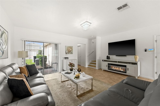 16162 Arbor Crest Aly, Winter Garden, FL 34787 - living room with light tile patterned floors, stairway, baseboards, and a glass covered fireplace