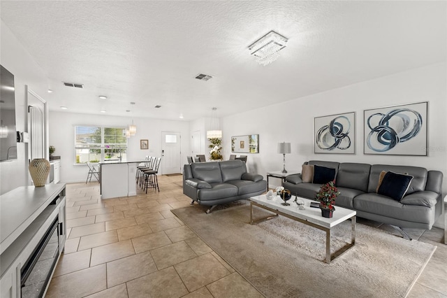 16162 Arbor Crest Aly, Winter Garden, FL 34787 - living area with a textured ceiling and light tile patterned floors