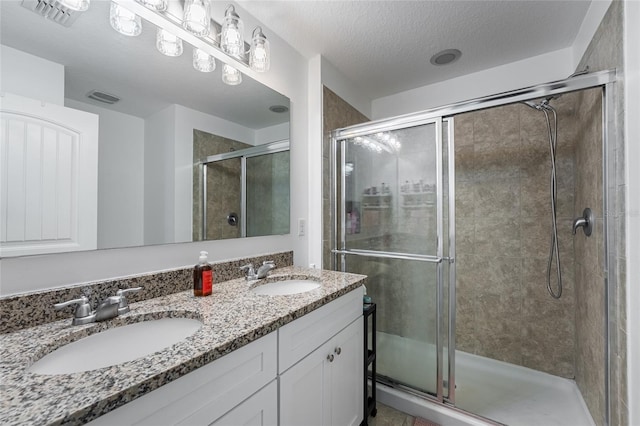 16162 Arbor Crest Aly, Winter Garden, FL 34787 - bathroom with a shower stall, double vanity, and a textured ceiling