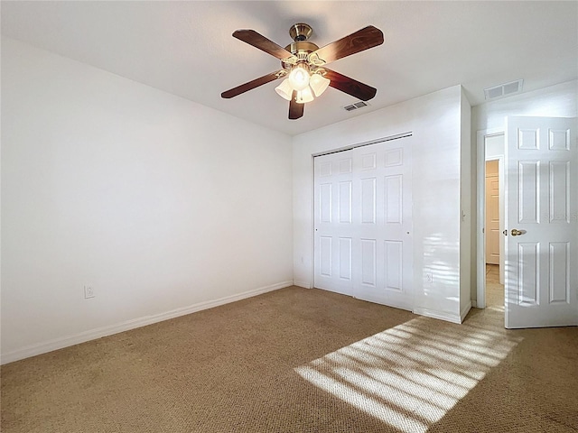 unfurnished bedroom featuring carpet, a closet, and baseboards