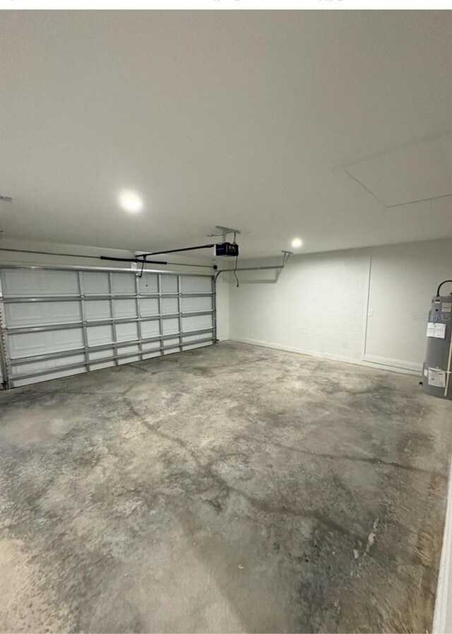 garage featuring electric water heater and a garage door opener