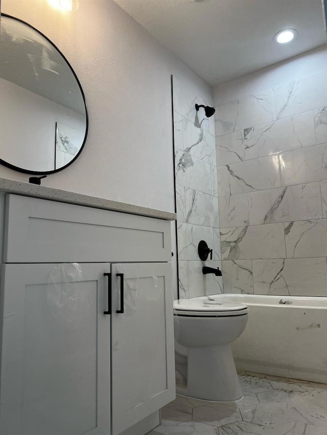 bathroom featuring marble look tile flooring, toilet, washtub / shower combination, vanity, and recessed lighting