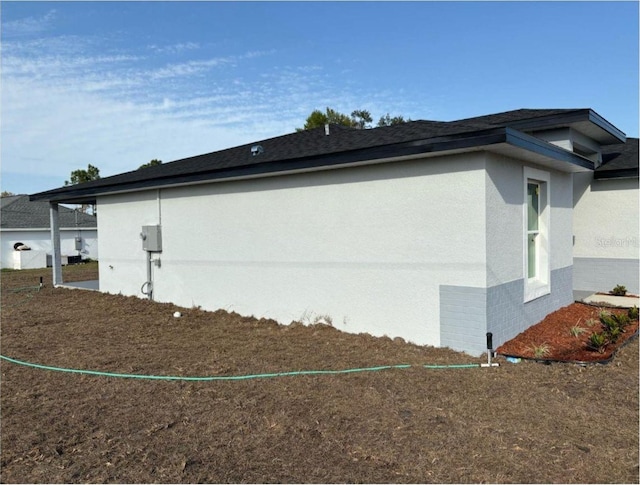view of side of property with stucco siding